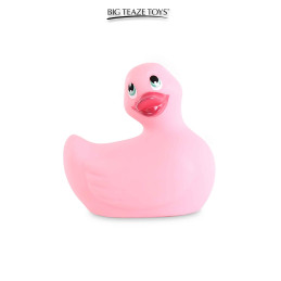 Canard vibrant Duckie 2.0 Classic – rose posé sur bord de baignoire, ambiance bain relaxant et douce lumière